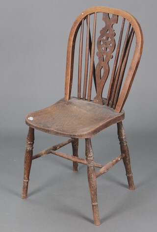 A 19th Century elm wheel back Windsor chair with pierced slat back and solid seat, raised on turned supports with H framed stretcher 