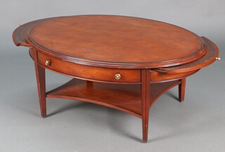An oval mahogany coffee table fitted brushing slide and two long drawers, raised on square tapering supports with shaped undertier 50h x 120w x 86d