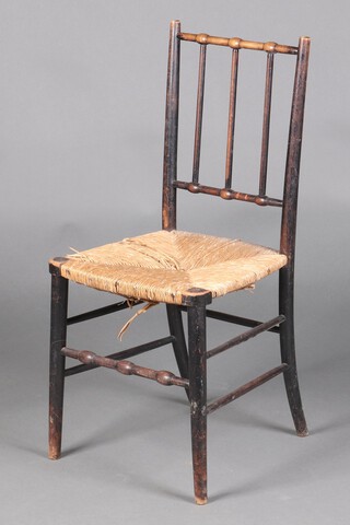 William Morris, an ebonised elm Sussex stick and rail back chair with woven rush seat, raised on turned supports 86cm h x 40cm w x 34cm d 