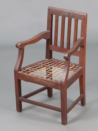 A child's South African hardwood open arm chair with splat back and woven hide seat, raised on square tapered supports with presentation plaque "With the compliments of Marico District to Lady Buxton" 60cm h x 36cm w x 28cm d 