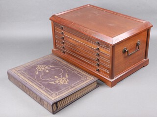 A rectangular mahogany table top coin collectors chest fitted 6 drawers with brass drop handles to the sides, raised on a platform base 24cm high x 44cm w x 29cm d, together with a coin collectors album 