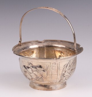 A Chinese silver bowl with embossed floral decoration and swing handle 11cm, the base marked Zeeshun, 6cm h, 157 grams 
