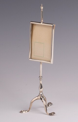 A novelty silver photograph frame in the form of a Georgian pole screen raised on a column and tripod base, London 1910 by The Goldsmiths & Silversmiths Company, 17cm h, 52 grams 