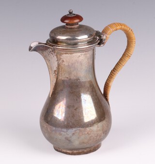A George II silver baluster cream jug with straw work handle, London 1755, makers marks rubbed, 14cm h, 238 grams 