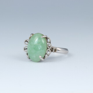An 18ct white gold ring set an oval cabochon cut green hardstone, size G 1/2, 4.6 grams  