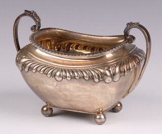 An Edwardian embossed silver twin handled sugar bowl jug, raised on bun supports, Sheffield 1905 by James Dixon & Sons, 255 grams 