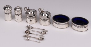 A 6 piece silver condiment set comprising pair of peppers, pair of salts and pair of mustard, with blue glass liners and spoons, Birmingham 1925 by Levi & Salaman, 150 grams together with 5 various salt spoons 