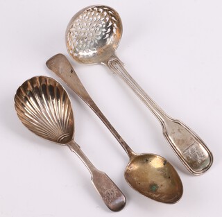A George III silver Old English pattern teaspoon London 1811, a William IV fiddle and thread pattern silver sifter spoon with armorial decoration,  London 1836 by William Eston, a Victorian silver Old English pattern caddy spoon with shell bowl London 1838, 57 grams 