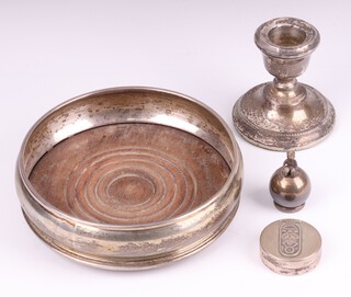 A circular silver wine coaster London 1977, 13cm diam., a squat silver candlestick, a Carrs Sterling silver paperweight decorated a teddybear 4cm and a Continental jar and cover 4cm 