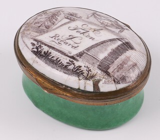 An 18th Century oval Bilston enamel patch box, the lid marked "A Token of Regard" the interior fitted a mirror (mirror cracked) 12cm x 4cm 