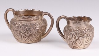A Victorian embossed silver twin handled sugar bowl together with a matching cream jug Birmingham 1889 by James Rooker, 6cm, 86 grams 
