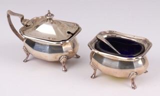 A rectangular silver mustard pot and salt of panelled form, with blue glass liners, Birmingham 1929, 107 grams 