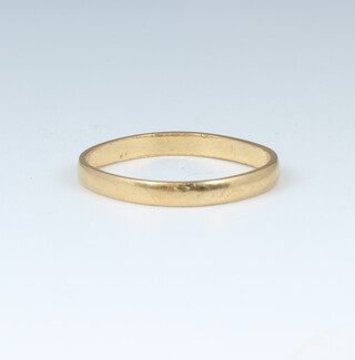 A yellow gold marked 750 wedding band, size L, (misshapen), 1.4