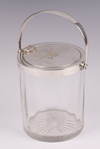 A cylindrical cut glass preserve jar with swing handle and patented silver rising lid, London 1904, by the Goldsmiths & Silversmiths Company, 9cm  