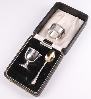 A silver christening set with egg cup and spoon, Birmingham 1967 and 1968, monogrammed, by Angora, together with a silver napkin ring Birmingham 1968, weighable silver 38 grams 