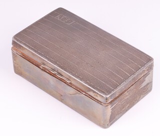 A rectangular silver cigarette box with engine turned decoration Birmingham 1929, monogrammed, 4cm x 14cm x 8cm, 