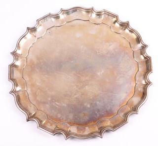 An Indian silver salver with bracketed border, engraved inscription "Presented to Brigadier H M Cox CIE OBE MC and Mrs Cox by The Senior Staff of Iscon Consortium at Durgapur July 1959", 30cm, 935 grams 