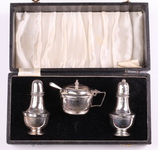 A matched silver 3 piece baluster shaped condiment set comprising mustard Birmingham 1965, salt Birmingham 1969 and pepper Birmingham 1959, together with a condiment spoon, marks rubbed, 89 grams
