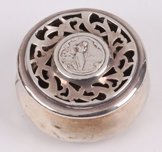 Of golfing interest, a circular silver pot pourri, the lid decorated a  lady golfer, London 1903 by William Comyns and Sons 2cm x 5cm, 39g