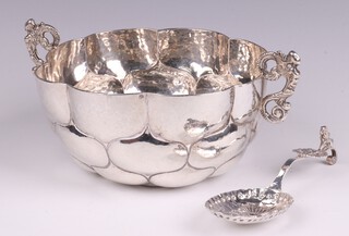 A Continental embossed silver spoon 12cm and a white metal twin handled bowl 14cm 