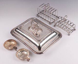 A rectangular silver plated entree dish and cover with bead work border, 2 toast racks and 2 wine tasters 