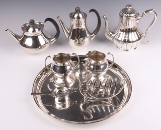 Eric Clements for Mappin & Webb, a 4 piece silver plated tea service comprising teapot, hot water jug, twin handled sugar bowl and milk jug, a Britannia metal coffee pot, circular silver plated tray, a toast rack in the form of a swan and a tea strainer 
