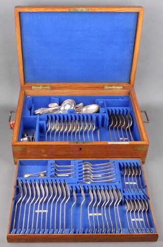 A quantity of silver plated flatware, Old English pattern and fiddle pattern, contained in an oak and brass banded canteen box, approx. 87 items 