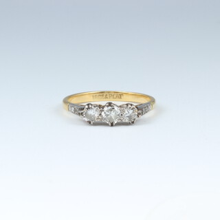An 18ct yellow gold and platinum ring set 3 diamonds, size L 1/2, 2.1 grams 