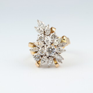 A yellow gold testing as 18ct floral spray ring set 11 oval cut diamonds and 4 circular cut diamonds, size M, 8.5 grams  