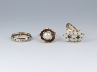 A yellow gold marked 14k ring set a pearl, size I 1/2, 2.8 grams, a 9ct gold floral ring set emeralds and opals, size L 1/2, 2.8 grams and a  9ct yellow gold eternity ring, size K 1/2 1.7 grams 
