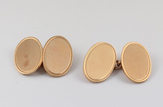 A pair of 9ct oval yellow gold cufflinks with engine turned decoration, 8.7 grams  