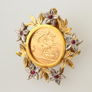 An Elizabeth II 2007 sovereign set in a yellow gold testing as 18ct brooch/pendant mount, set red stones, 22.6 grams 