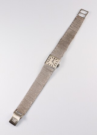 A lady's Omega wristwatch with square white dial and batons, contained in a 9ct white gold case with integral bracelet, movement marked Omega 485 35657532, the case marked Omega Watch Company no.7115698, gross weight including movement 19.6 grams, boxed