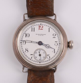 A gentleman's Waltham wristwatch with enamelled dial, seconds at 6 o'clock, Arabic numerals, contained in a silver case on a leather strap 