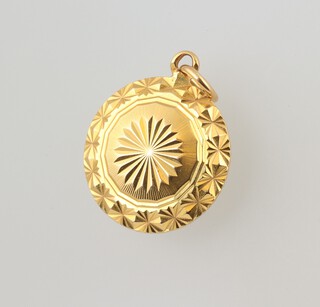A yellow gold, testing as 18ct circular pendant, 4.1 grams 