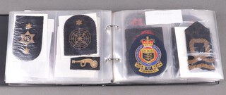 An album containing a collection of British Military cloth insignia including Air Force and Royal Navy 