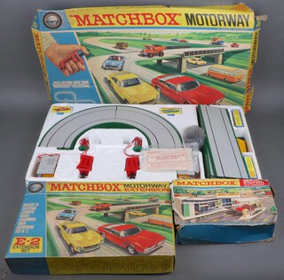 A Matchbox M-2 motorway boxed (tears to the box), ditto E2 motorway extension boxed and a Service Station boxed (box damaged) 