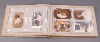 An album of 252 Edwardian and later black and white and coloured postcards