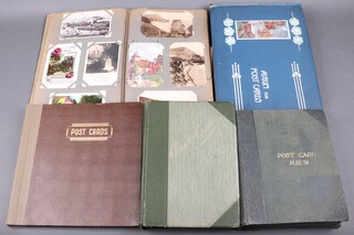 Five albums of Edwardian and later black and white and coloured postcards, approx. 766  