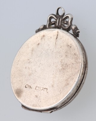 A silver double photograph locket  (some dents) 