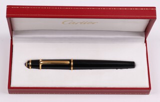 A Cartier black cartridge fountain pen with gilt mounts, cased 