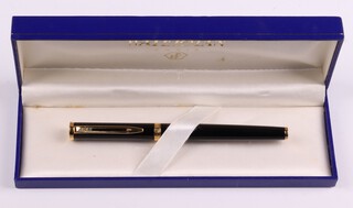 A Waterman black cartridge fountain pen the nib marked Paris 18k 750, contained in a black and gilt case 
