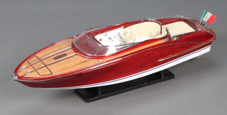 A wooden model of an Italian speed boat Riva Roma on stand 26cm h x 90cm w x 27cm d 