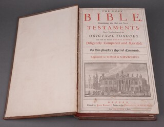 The Holy Bible containing The Old and New Testament newly tranflated out of the original tongues, printed by John Basket, Oxford, 1727, fully bound in reverse calf with blind stamped decoration comprising grid and 4 corner fleur de lis, the spine with raised bands, 1 section in red  Morocco with gilt lettering, the others blind stamped geometric designs containing fleur de lis, folio 
