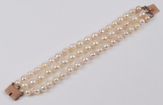 A 3 row cultured pearl bracelet with yellow gold, testing as 9ct clasp, 20.5cm 