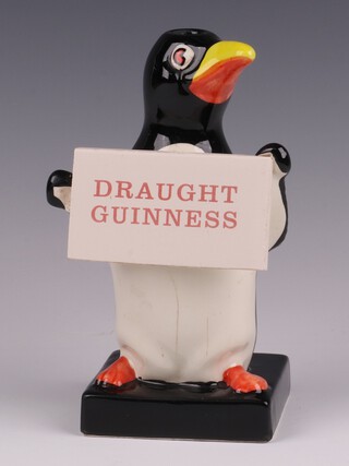 A Carlton Ware advertising lamp base - Draught Guinness, in the form of a standing penguin on a square base, 18cm 