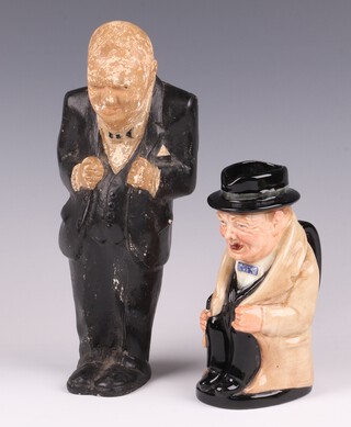 A Royal Doulton character jug in the form of a seated Sir Winston Churchill, no.6, 13cm together with a plaster figure of a standing Churchill 22cm (no cigar) 