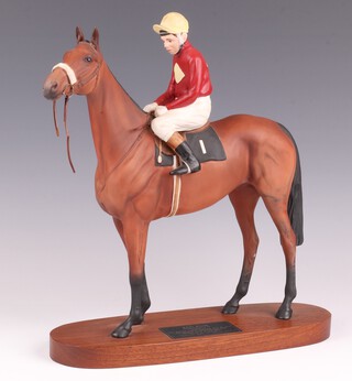 A Beswick figure of the racehorse Red Rum with jockey up, on an oval base 32cm h 