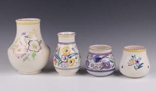 A Poole Pottery vase the base impressed 203 with floral decoration, 20cm, ditto 266 15cm and 2 other Poole Pottery vases 10cm   