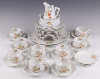 A 35 piece German porcelain tea service with floral decoration comprising 2 bread plates, milk jug, sugar bowl, 11 tea plates (1 cracked),  9 teacups and 11 saucers